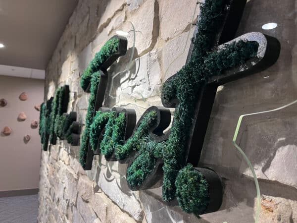 Moss wall in office logo