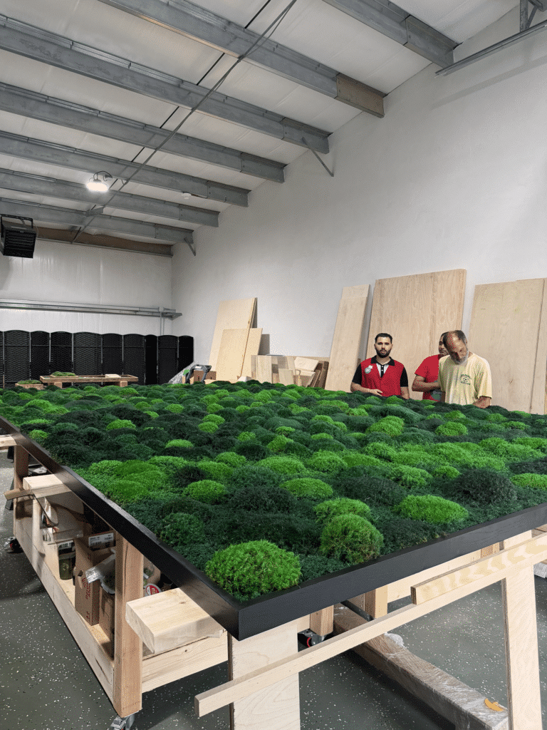 Large living moss wall as an architectural centerpiece in a luxury home interior.