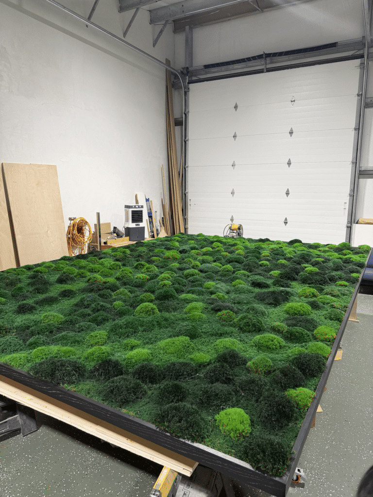 Large living moss wall as an architectural centerpiece in a luxury home interior.