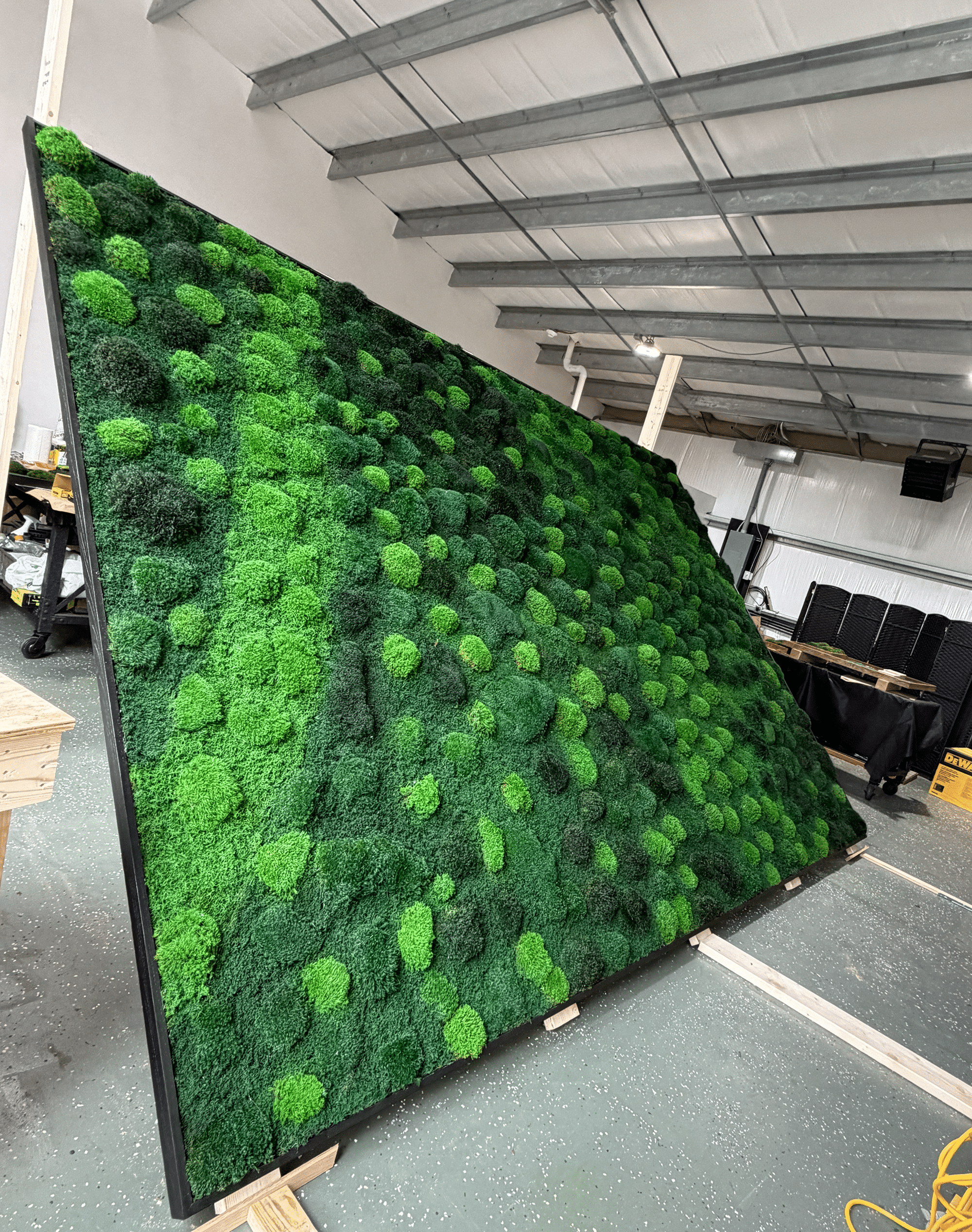 Large living moss wall as an architectural centerpiece in a luxury home interior.