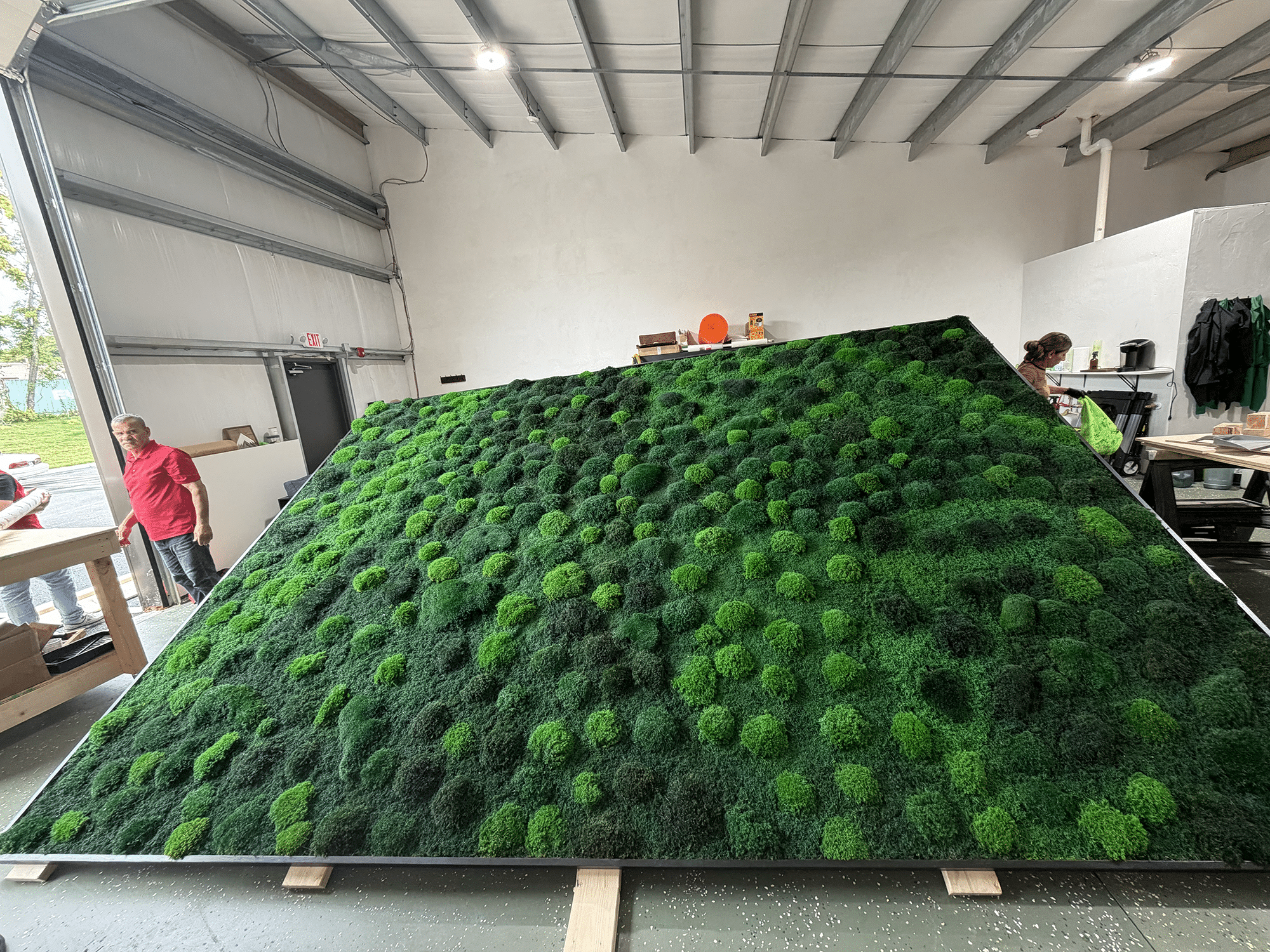 Large living moss wall as an architectural centerpiece in a luxury home interior.