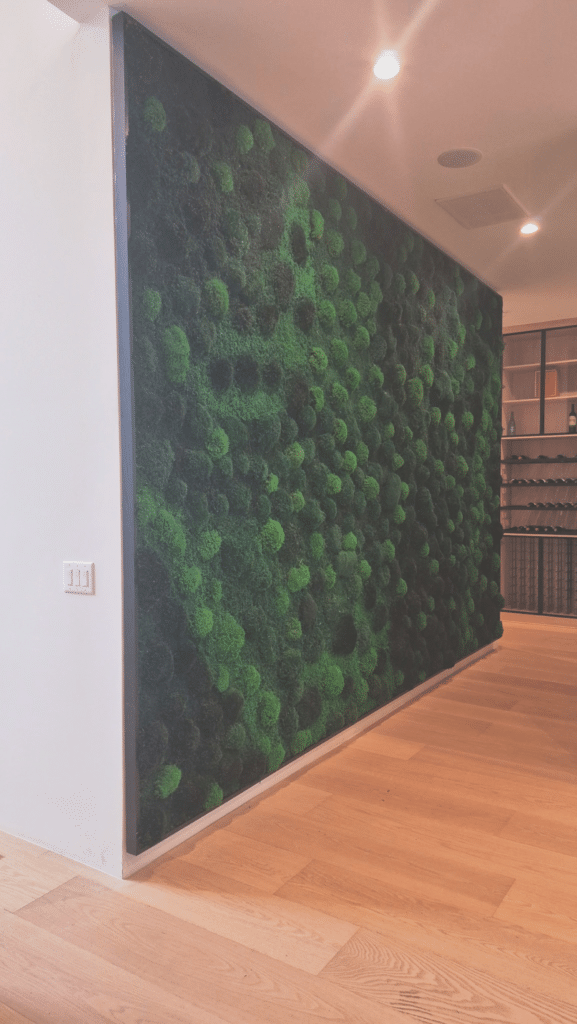 Large living moss wall as an architectural centerpiece in a luxury home interior.