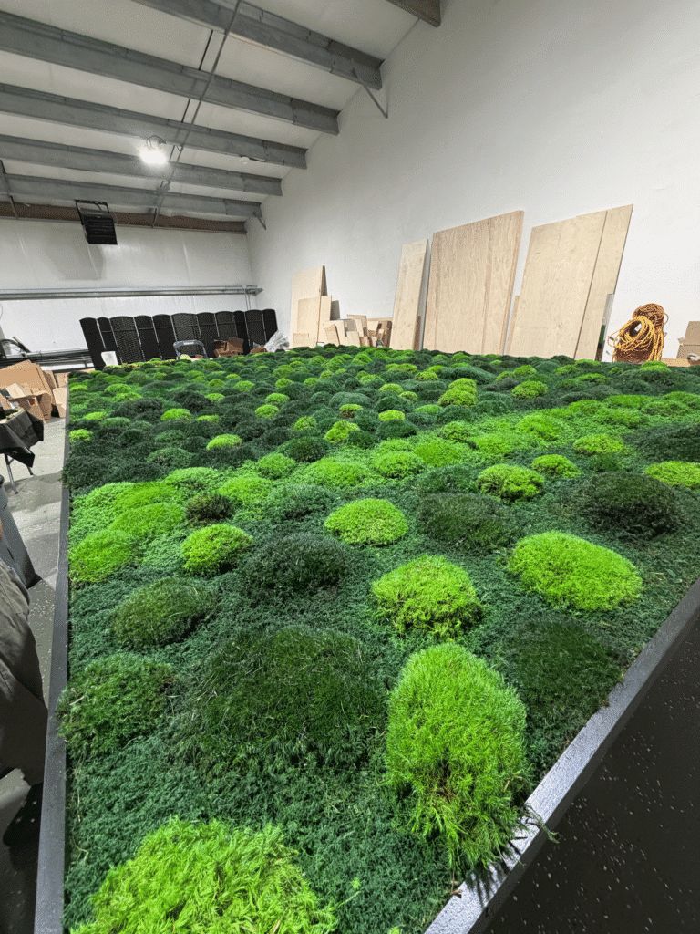 Large living moss wall as an architectural centerpiece in a luxury home interior.